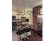 Charming kitchen with a black countertop island, stainless steel appliances, and a striking brick accent wall at 24 Moreland Ne Ave, Atlanta, GA 30307