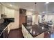 Open kitchen featuring stainless appliances, a center island with seating, and a brick accent wall at 24 Moreland Ne Ave, Atlanta, GA 30307