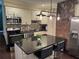 Modern kitchen featuring stainless steel appliances, granite countertops, and a stylish brick accent wall above the oven at 24 Moreland Ne Ave, Atlanta, GA 30307