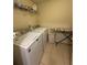 Functional laundry room with modern washer, dryer, and overhead shelving at 24 Moreland Ne Ave, Atlanta, GA 30307