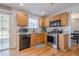 Corner view of a kitchen with stainless steel appliances and wood cabinets at 351 Grandview Cir, Powder Springs, GA 30127