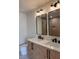 Bathroom featuring double vanity sinks, white marble countertop, and modern lighting at 602 Birch River Ln, Lawrenceville, GA 30043