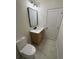 Stylish bathroom with marble tile, modern fixtures, wood vanity, and a toilet at 602 Birch River Ln, Lawrenceville, GA 30043