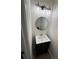 Modern bathroom with a black vanity, round mirror, and stylish lighting at 602 Birch River Ln, Lawrenceville, GA 30043