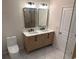 Bathroom featuring double vanity sinks, white marble countertop, and modern lighting at 602 Birch River Ln, Lawrenceville, GA 30043