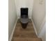 Modern bathroom with a black toilet, neutral walls, and hardwood floors at 602 Birch River Ln, Lawrenceville, GA 30043