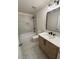 Stylish bathroom with marble tile, a bathtub, modern fixtures, and wood vanity at 602 Birch River Ln, Lawrenceville, GA 30043