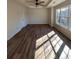 Bright bedroom featuring hardwood floors, ceiling fan and large windows for ample natural light at 602 Birch River Ln, Lawrenceville, GA 30043