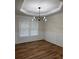 Dining room with modern chandelier, wainscoting and large window at 602 Birch River Ln, Lawrenceville, GA 30043