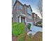 Brick townhome featuring a two-car garage, covered entry, and neatly trimmed front bushes at 602 Birch River Ln, Lawrenceville, GA 30043