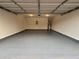 Well-lit two-car garage featuring epoxy flooring and high ceilings at 602 Birch River Ln, Lawrenceville, GA 30043