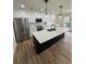 Modern kitchen with stainless steel appliances, white cabinets, island and pendant lighting at 602 Birch River Ln, Lawrenceville, GA 30043