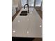 White quartz countertop on kitchen island with stainless steel sink and goose neck faucet at 602 Birch River Ln, Lawrenceville, GA 30043
