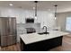 Modern kitchen with stainless steel appliances, island with white countertop, and stylish pendant lighting at 602 Birch River Ln, Lawrenceville, GA 30043