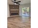 Bright living room featuring a modern fireplace, ceiling fan, and sliding glass doors to the outdoor deck at 602 Birch River Ln, Lawrenceville, GA 30043