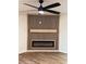 Modern living room with an electric fireplace, custom wood accent wall, and ceiling fan at 602 Birch River Ln, Lawrenceville, GA 30043