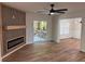 Open-concept living area featuring a modern fireplace, wood floors, and access to an outdoor deck at 602 Birch River Ln, Lawrenceville, GA 30043