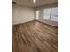 Open living room featuring hardwood floors, neutral walls, and a large window at 602 Birch River Ln, Lawrenceville, GA 30043