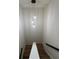 Staircase with globe pendant lights, wood treads, white risers and black railings at 602 Birch River Ln, Lawrenceville, GA 30043