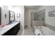 Modern primary bath features a double vanity, soaking tub, and glass enclosed shower at 2051 Glenview Park Cir, Duluth, GA 30097