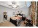 Inviting bedroom with tray ceiling, floral curtains, bed, and neutral walls at 2051 Glenview Park Cir, Duluth, GA 30097