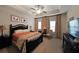 Spacious bedroom with tray ceiling, floral curtains, a bed, and neutral walls at 2051 Glenview Park Cir, Duluth, GA 30097