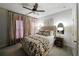 Comfortable bedroom featuring a floral bedspread, neutral walls, and warm lighting at 2051 Glenview Park Cir, Duluth, GA 30097