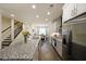 Modern kitchen features granite countertops, stainless steel appliances, and seamlessly flows into the dining area at 2051 Glenview Park Cir, Duluth, GA 30097