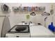 Efficient laundry room with washer, dryer, wire shelving, ironing board and storage at 2051 Glenview Park Cir, Duluth, GA 30097