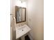 Compact powder room features a pedestal sink and a decorative mirror at 2051 Glenview Park Cir, Duluth, GA 30097