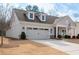 Charming home featuring a two-car garage, dormer windows, manicured lawn, and welcoming front porch at 4901 Pleasantry Nw Way, Acworth, GA 30101