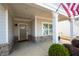 Inviting covered front porch with stone accents and a view of the home's entry at 4901 Pleasantry Nw Way, Acworth, GA 30101