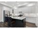 Bright kitchen featuring white cabinets, stainless steel appliances, and an island with barstool seating at 4901 Pleasantry Nw Way, Acworth, GA 30101