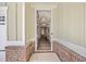 Home's welcoming front entrance featuring brick accents, a secure storm door, and a view into the foyer at 1019 Cooks Farm Way, Woodstock, GA 30189