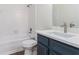 Bathroom with blue vanity, white countertop, and combined shower and tub at 4051 Ridgehurst Se Dr, Smyrna, GA 30080