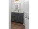 Bathroom vanity with dark gray cabinetry, marble countertop, and stylish lighting at 4051 Ridgehurst Se Dr, Smyrna, GA 30080