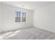 Spacious bedroom features a window with natural light and neutral carpet at 4051 Ridgehurst Se Dr, Smyrna, GA 30080