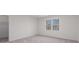 Bright, empty bedroom with a window and a view to a walk-in closet at 4051 Ridgehurst Se Dr, Smyrna, GA 30080