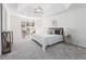 Bright bedroom featuring a tray ceiling, a large window, and neutral-toned decor at 4051 Ridgehurst Se Dr, Smyrna, GA 30080