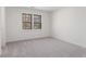 Neutral bedroom with a large window providing natural light and carpeted flooring at 4051 Ridgehurst Se Dr, Smyrna, GA 30080