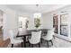 Formal dining room with elegant lighting, white chairs and decorative rug at 4051 Ridgehurst Se Dr, Smyrna, GA 30080