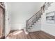 Elegant entryway with wood floors, staircase with iron railings, and natural light streaming in at 4051 Ridgehurst Se Dr, Smyrna, GA 30080