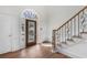 Bright foyer featuring hardwood floors, staircase with iron railings and glass door at 4051 Ridgehurst Se Dr, Smyrna, GA 30080