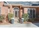 Inviting front entrance with a brick facade, decorative plants and stone steps at 4051 Ridgehurst Se Dr, Smyrna, GA 30080