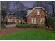 Charming brick home with a well-kept lawn and established landscaping, viewed at dusk at 4051 Ridgehurst Se Dr, Smyrna, GA 30080