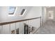 Upstairs hallway with three skylights and wooden handrail at 4051 Ridgehurst Se Dr, Smyrna, GA 30080
