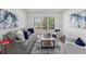 Comfortable living room featuring neutral decor, large windows, and decorative art at 4051 Ridgehurst Se Dr, Smyrna, GA 30080