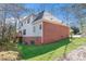 Back view of the property showing brick and siding, deck, and sloping yard at 4051 Ridgehurst Se Dr, Smyrna, GA 30080