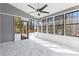 Bright sunroom with marble tile flooring, many windows, and an overhead ceiling fan at 4051 Ridgehurst Se Dr, Smyrna, GA 30080