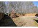 Fenced backyard featuring a wooden playset, offering a safe and fun space for children to play at 102 Crescent Woode Way, Dallas, GA 30157